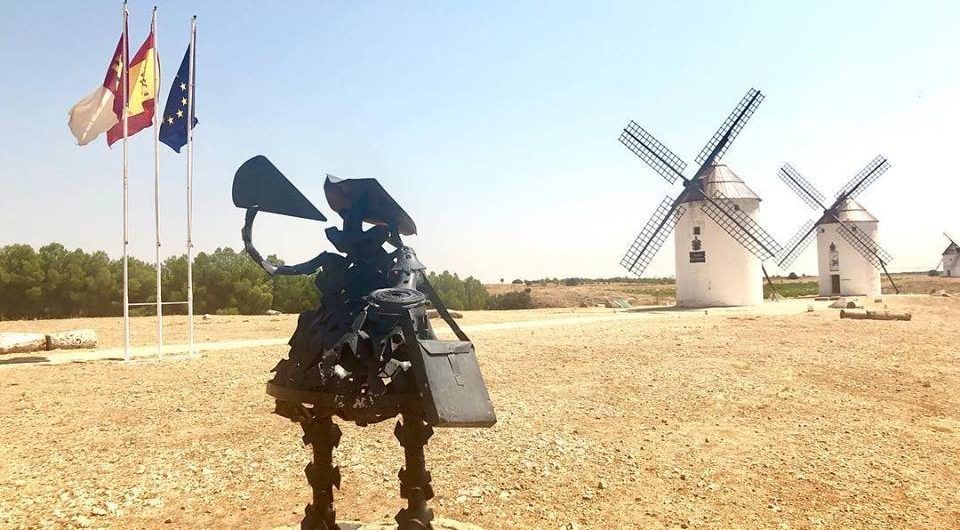 Sancho Panza is drinking wine in the windmills of La Mancha